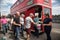 People making donations to a charity collection bucket to ride on a classic bus