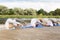 People making yoga in plow pose on mat outdoors