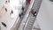People on many fast moving escalators in modern building. 7 march 2020. Groningen NETHERLANDS.