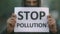 People in mask closeup look at camera background road with banner stop pollution