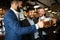 People, men, leisure, friendship and celebration concept. Happy male friends drinking beer at pub