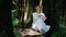 People and mental healthy positive mindful lifestyle. One serene and cheerful woman sitting under a tree in nature outdoor woods.