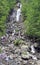 People at milky waterfall in Abkhazia