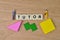 People miniatures, wooden blocks and square letters with text TUTOR