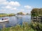 People on motorboats cruising on river Boorne in Akkrum, Friesland, Netherlands