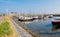 People, motorboats and sailboats in marina of West Frisian island Schiermonnikoog, Netherlands