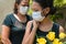 People mourning those lost to the coronavirus, wearing face masks, showing mutual support