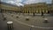 People moving among black and white columns in Royal Palace courtyard in Paris