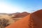 People on Namib desert dunes, travel in Africa