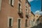 People on narrow alley and colorful building at Avila