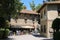 People near small tourist restaurant in medieval castle. Grazzano Visconti, Italy