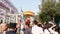 people offering food and items to a buddhist monk and being blessed in temple