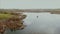 People in old boat on the lake in spring time. Aerial view.