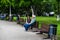 People old couple standing on benches, relaxing and have fun in park, freshly mowed grass.  Bucharest, Romania, 2020