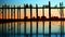 People on the old teak bridge. Burma, Mandalay, sunset