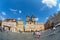 People in the Old Town Square the view on Tyn church and Jan Hus monument. Photo taken with a fisheye lens.