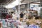 People in open air marketplace and shop, objects and things on the shelfâ€™s