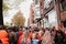 People in orange clothing are sailing in a boat on the canals of Amsterdam on King\\\'s Day