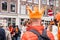 People in orange clothing are sailing in a boat on the canals of Amsterdam on King\\\'s Day