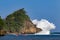 People paddling on kayak in lagoon on breaking waves background