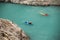 People paddling by kayaks with dogs through the turquoise river in Congost de Mont-Rebei gorge, Catalonia, Spain.