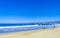 People parasols sun loungers beach waves palms Zicatela Mexico