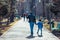 People on the park alley on a warm February day.