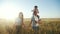 People in the park. happy silhouette family sunset walk. mom dad and daughter walk holding hands in the park. happy