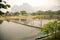 people passing bamboo bridge on limestone mountain background