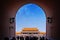 People passing through one of the internal red colored gates of the Palace Museum, known as the Forbidden City, in