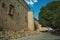 People on pedestrian promenade beside large city wall at Avila