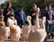 People photograph colourful pink pelicans with long beaks, by the lake in St James\'s Park, London UK.