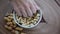 People picking peanuts from a small portion in the center. Wood background