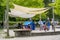 People are on a picnic and walk in the memorial park at Marselisborg Castle, children on a playground