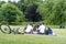 People are on a picnic and walk in the memorial park at Marselisborg Castle, green grass, green trees
