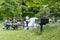 People are on a picnic and walk in the memorial park at Marselisborg Castle, green grass, green trees