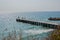 People on a pier with statue of Poseidon, blue sea and sky, holiday destination - St Constantine and Elena, Varna, Bulgaria