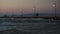 People on pier in the windy evening