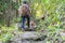 People with Pit Bull dogs on a hiking trail in nature.