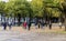 People play classic French petanque boule game on the ground at Les Invalides park in central Paris