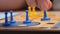 People play Ludo or Pachisi board game on beautiful wooden play board. Ludo is a strategy board game for two to four