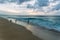 People playing on the beach with big waves on the north shore of Oahu