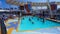 People playing at pool at upper deck in mini volleyball at cruise at cruise liner or ship