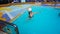 People playing at pool at upper deck in mini volleyball at cruise at cruise liner or ship