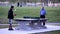 People playing table tennis and make a phone call at park