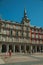 People on the Plaza Mayor with old large building in Madrid