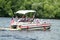 People on pontoon in parade on the river to celebrate Independence Day, the Fourth of July