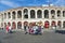 People pose at the arena of Verona