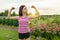 People, power, stamina, strength, health, sport, fitness concept. Outdoor portrait smiling teenage girl flexing her muscles, backg