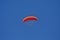 People practicing paragliding in a blue sky II